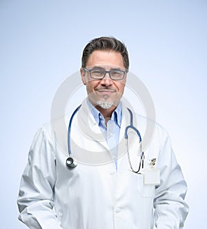 Portrait of happy smiling mid adult medical doctor on white