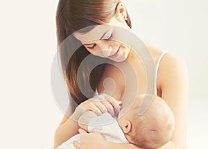 Portrait happy smiling mother feeding breast her baby at home