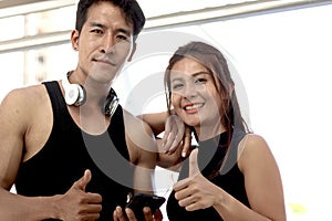 Portrait of happy smiling partner buddy runner man and woman lover giving thumbs up, exercise run outdoor, partner buddy runner