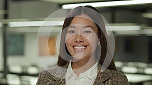 Portrait happy smiling positive Asian woman business manager worker female employer entrepreneur Chinese businesswoman