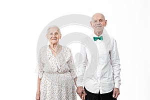 Portrait of happy, smiling, romantic senior man with his wife, old woman in white dress and old man in white shirt