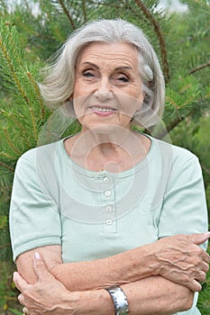 Portrait of happy smiling senior woman posing outdoors