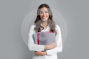 Portrait of happy smiling student or teacher. College or high school ducation. Young woman with notebooks smiling at