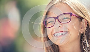 Portrait of a happy smiling teenage girl with dental braces and