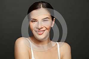 Portrait of happy smiling woman brunette model with clean fresh skin. Facial treatment, cosmetology, beauty and spa concept