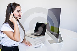 Portrait of happy smiling woman customer support phone operator at workplace