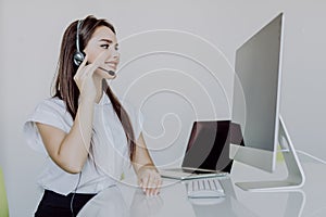 Portrait of happy smiling woman customer support phone operator at workplace