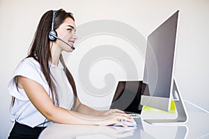 Portrait of happy smiling woman customer support phone operator at workplace