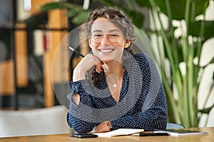 Portrait of happy smiling woman at desk