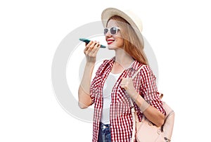 Portrait of happy smiling woman holding smartphone using voice command recorder or calling, wearing summer round straw hat with