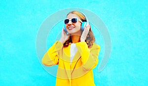 Portrait happy smiling woman listens to music in headphones