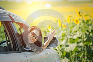 Portrait happy, smiling woman sitting in the car looking out windows, ready for vacation trip