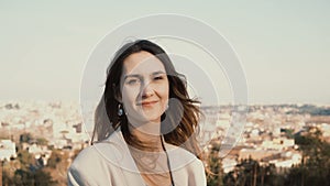 Portrait of happy smiling woman standing against the panorama of Rome, Italy. Female looking at camera, enjoying the day