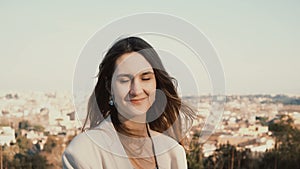 Portrait of happy smiling woman standing against the panorama of Rome, Italy. Female looking at camera, enjoying the day