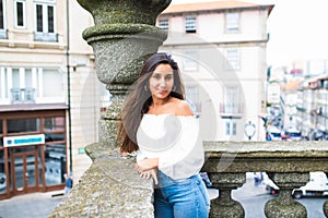 Portrait of happy smiling woman standing on the square on sunny summer or spring day outside, cute smiling woman looking at you, a