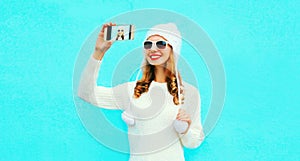 Portrait happy smiling woman taking selfie picture by smartphone