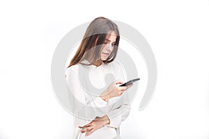 Portrait happy, smiling woman texting on her smart phone, isolated white background. Communication concept. Internet, phone addict