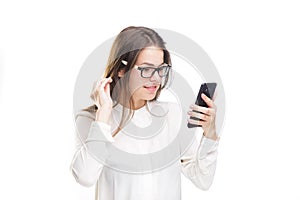 Portrait happy, smiling woman texting on her smart phone, isolated white background. Communication concept. Internet, phone addict