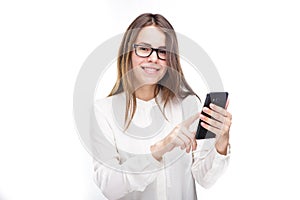 Portrait happy, smiling woman texting on her smart phone, isolated white background. Communication concept. Internet, phone addict