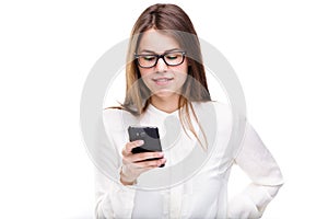 Portrait happy, smiling woman texting on her smart phone, isolated white background. Communication concept. Internet, phone addict