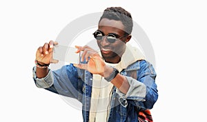 Portrait of happy smiling young african man taking selfie with smartphone isolated on white background