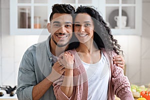 Portrait Of Happy Smiling Young Arab Couple Embracing And Smiling At Camera