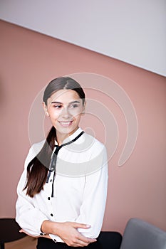 Portrait of happy smiling young cheerful brunette businesswoman