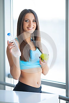 Portrait Of Happy Smiling Young Woman With Bottle Of Fresh Water