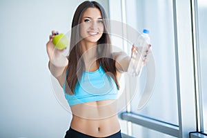 Portrait Of Happy Smiling Young Woman With Bottle Of Fresh Water