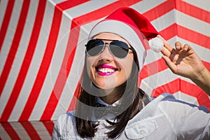 Portrait of a happy smiling young woman in Santa Claus hat