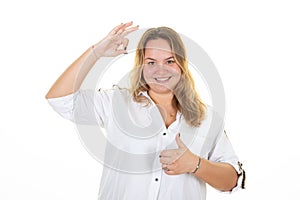 Portrait of happy smiling young woman showing thumb up palm and ok finger gesture on white background