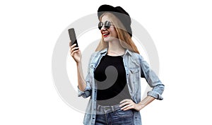 Portrait of happy smiling young woman with smartphone wearing black round hat isolated on white background