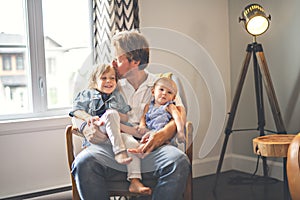 Portrait of happy son and baby daughter with father at home