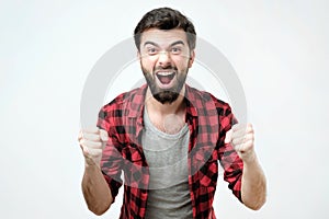 Portrait of happy spanish man with fists up celebrating his victory