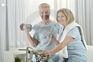 Portrait of happy sporty senior couple exercising