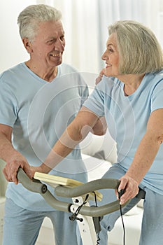 Portrait of happy sporty senior couple exercising