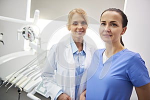 Portrait of happy stomatologist and her dental assistant