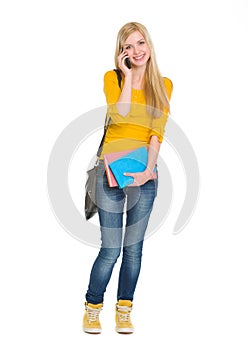 Portrait of happy student girl speaking mobile
