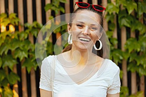 Portrait of happy stylish 40 years old woman in white shirt