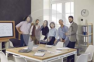 Portrait of happy successful diverse business team gathered in boardroom