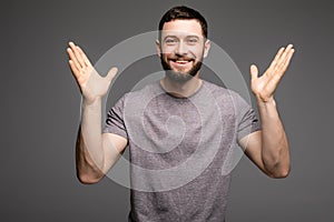 Portrait of happy successful man with raised hands