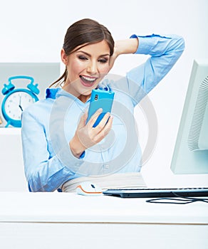 Portrait of happy surprised business woman on phone in white of