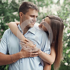 Portrait of happy sweet young smiling couple in love