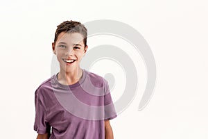 Portrait of happy teenaged disabled boy with cerebral palsy smiling at camera, posing isolated over white background