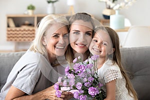 Portrait of happy three generations women family celebrating bir