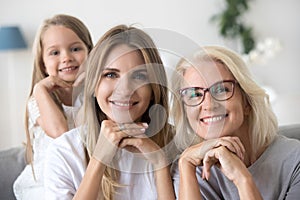 Portrait of happy three women generation grandma mom and child