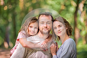 Portrait of a happy traditional family on walk in a summer park