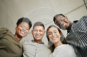 Portrait of happy united young business team hugging each other. Diverse mixed race group of men and women standing in