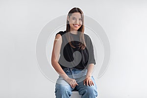 Portrait of happy vaccinated woman with plaster bandage on her arm after covid-19 vaccine injection on light background