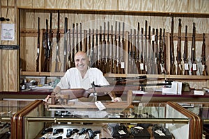 Portrait of a happy weapon shop owner photo